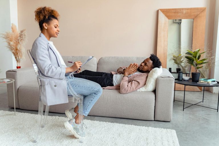Patient and therapist in a modern therapy session indoors.